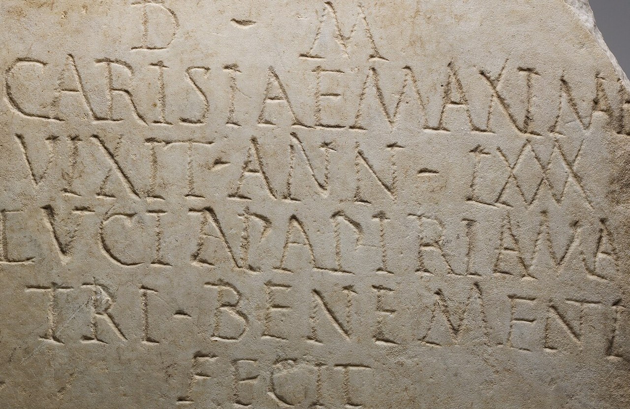 Glyphic: a Roman marble funerary plaque, the capitals cut with a chisel, their stems flared and their serifs small wedges, at the Metropolitan Museum of Art.